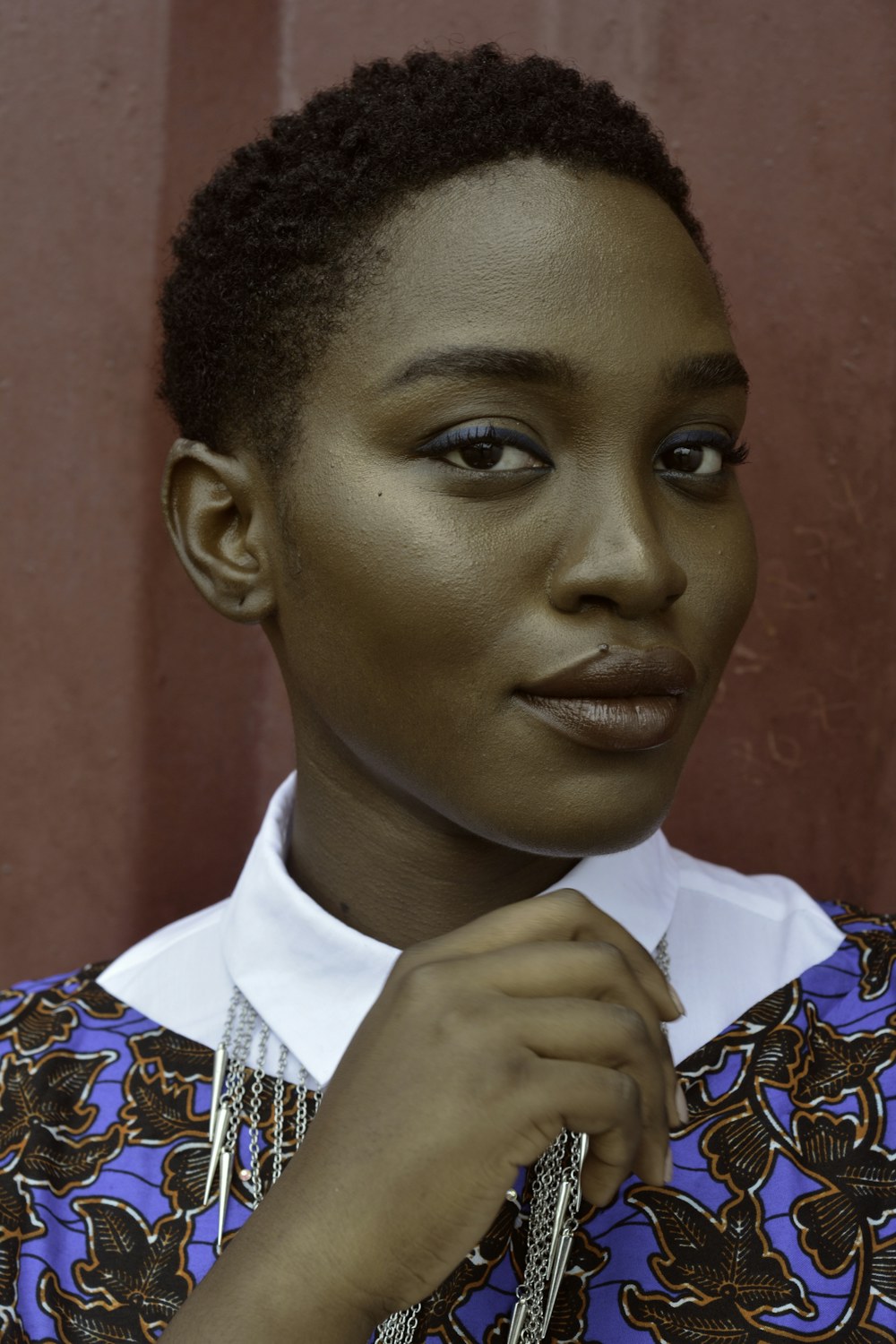 Portrait of Samira Okafor against a blue background.
